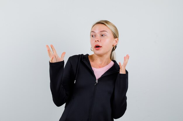 Young blonde woman in a black jacket