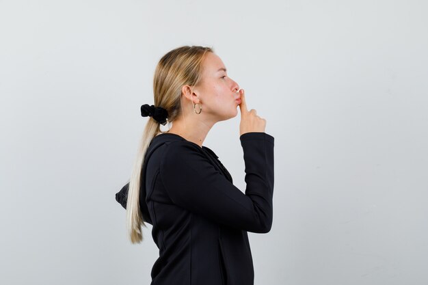 Young blonde woman in a black jacket