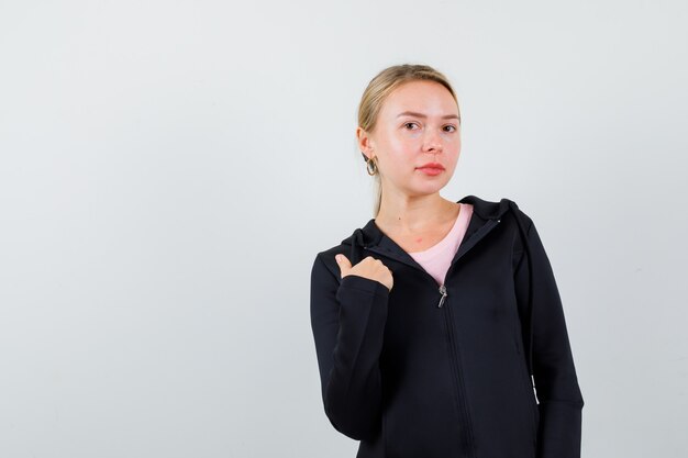 Young blonde woman in a black jacket