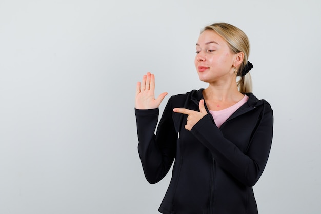 Free photo young blonde woman in a black jacket