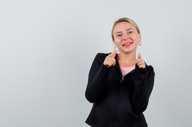 Young blonde woman in a black jacket