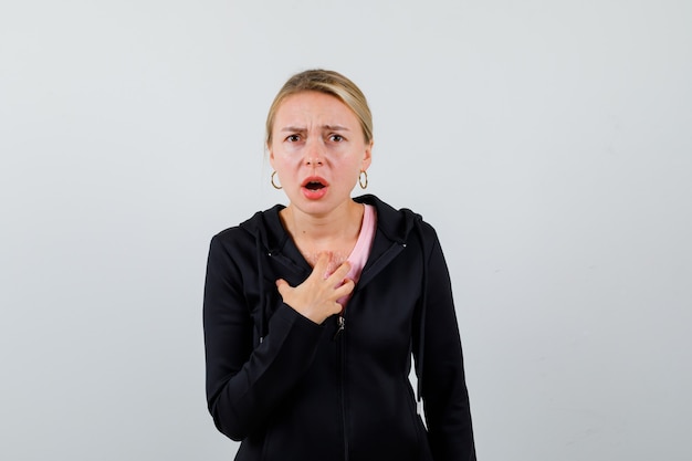 Young blonde woman in a black jacket