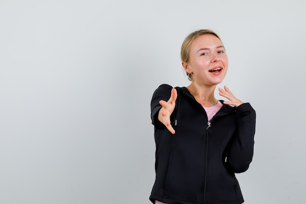 Young blonde woman in a black jacket