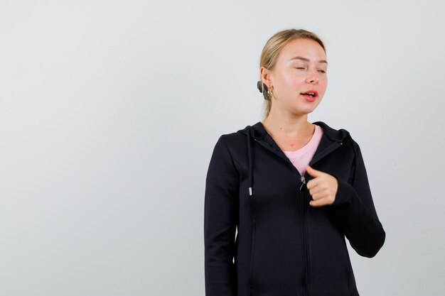 Young blonde woman in a black jacket