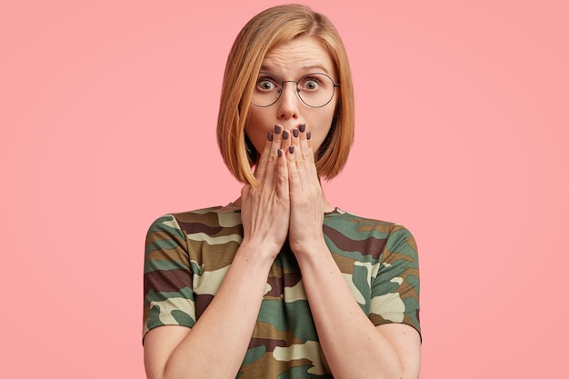 Young blonde woman in camouflage T-shirt