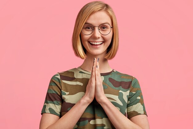 Young blonde woman in camouflage T-shirt