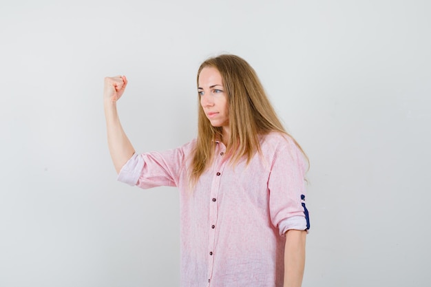 Free photo young blonde woman in a casual pink shirt