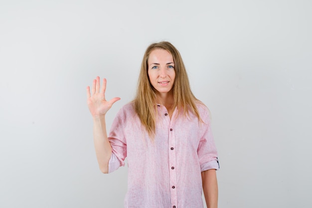 Free photo young blonde woman in a casual pink shirt