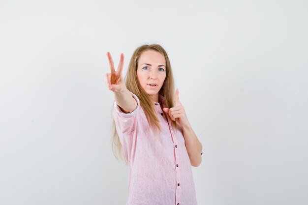 Young blonde woman in a casual pink shirt