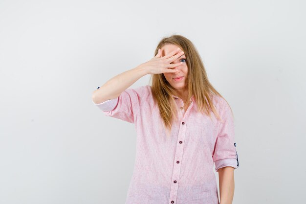 Young blonde woman in a casual pink shirt