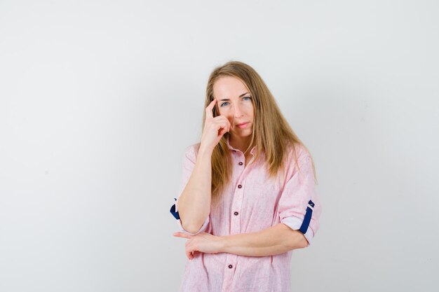 Young blonde woman in a casual pink shirt