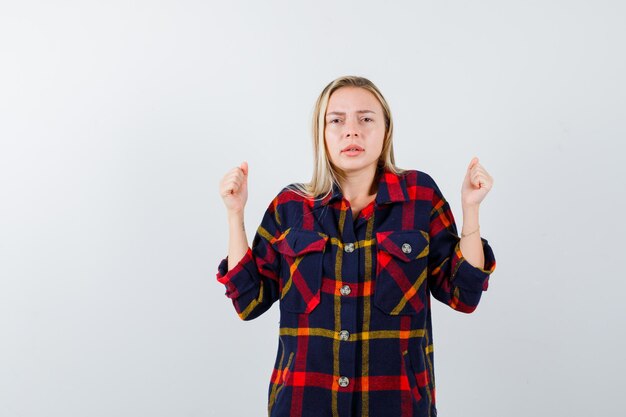 Young blonde woman in a checkered shirt