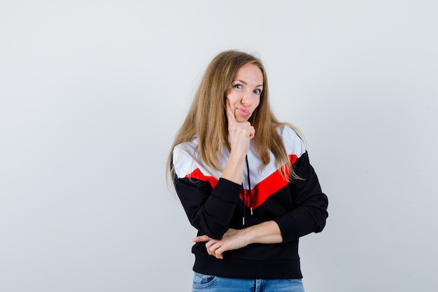 Young blonde woman in a jacket and jeans