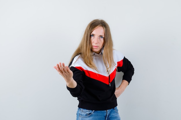 Young blonde woman in a jacket and jeans