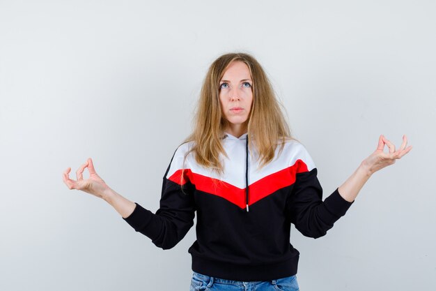 Young blonde woman in a jacket and jeans