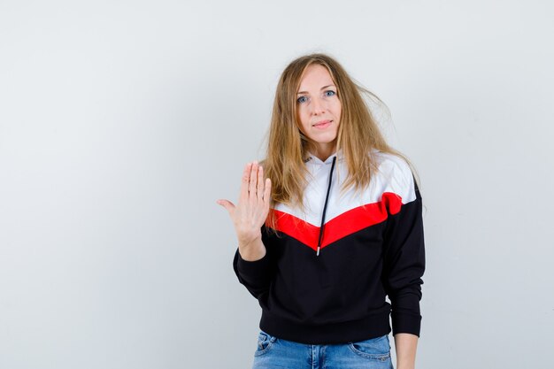 Young blonde woman in a jacket and jeans