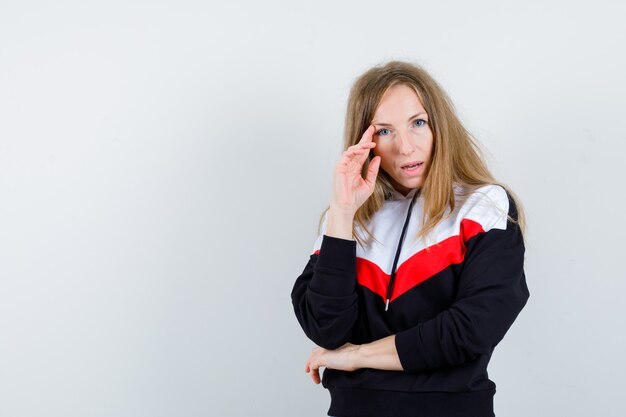 Young blonde woman in a jacket and jeans