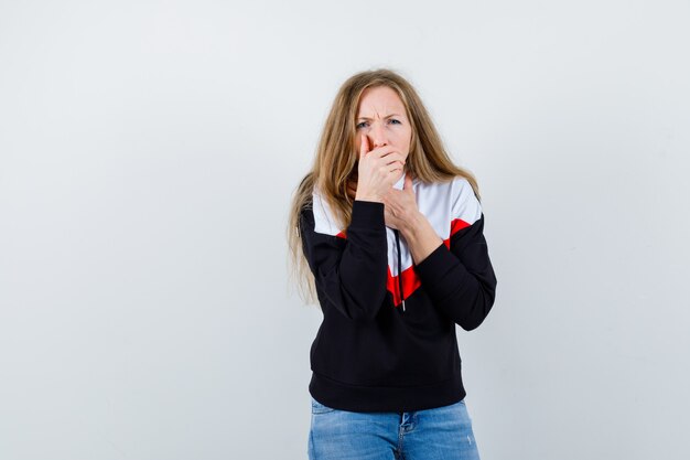 Young blonde woman in a jacket and jeans