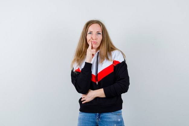 Young blonde woman in a jacket and jeans