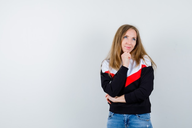 Young blonde woman in a jacket and jeans