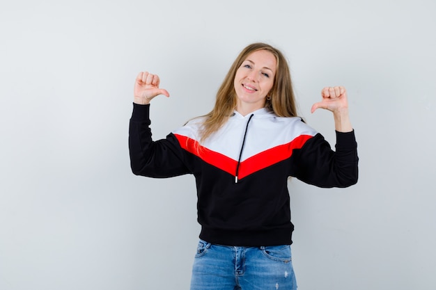 Giovane donna bionda in una giacca e jeans