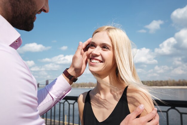 Young blonde woman looking at her man