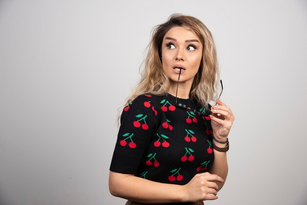 Young blonde woman posing with glasses. 