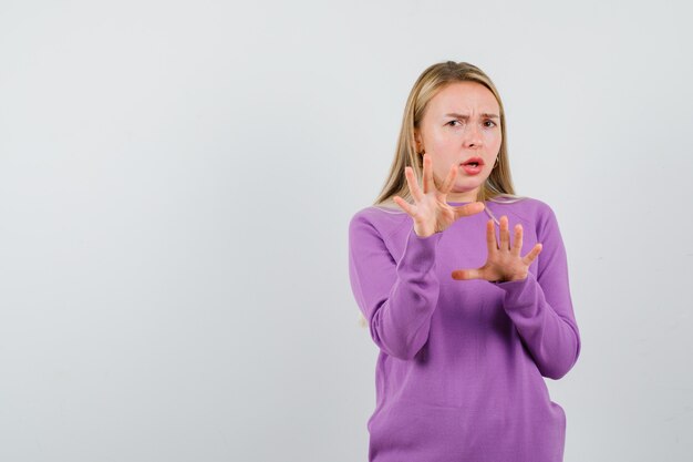 Young blonde woman in a purple sweater