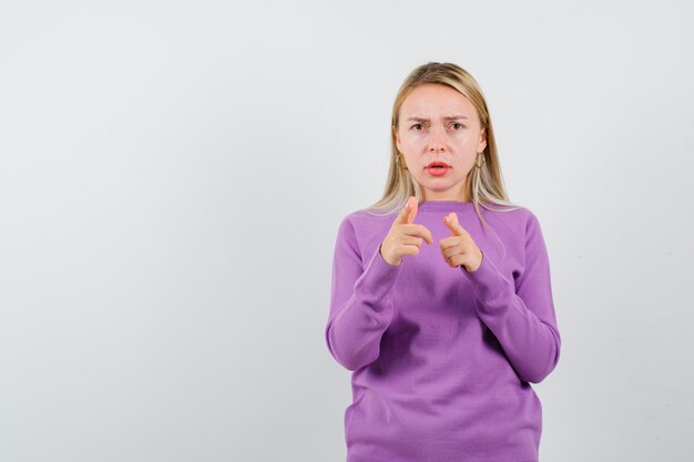 Young blonde woman in a purple sweater