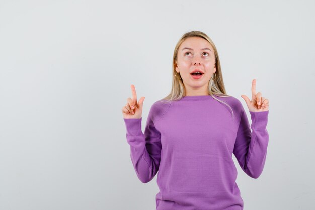 Young blonde woman in a purple sweater