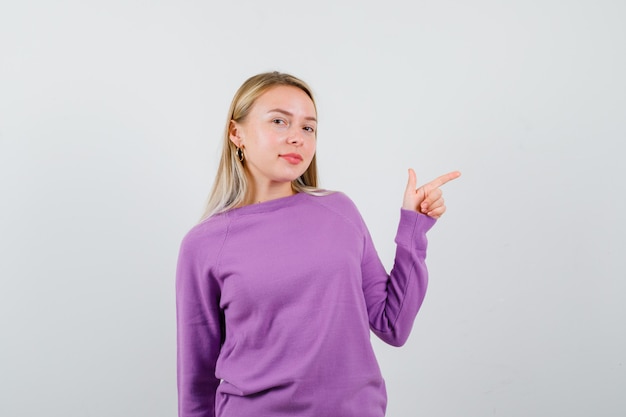 Young blonde woman in a purple sweater