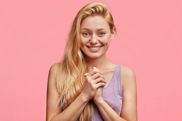 Young blonde woman in purple top