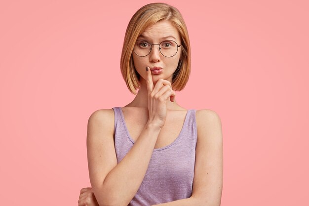 Young blonde woman in purple top