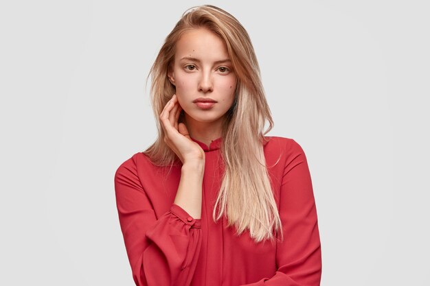 Young blonde woman in red shirt