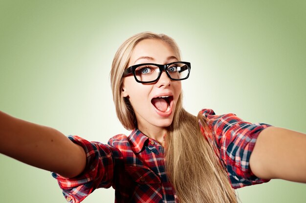 Young blonde woman taking selfie