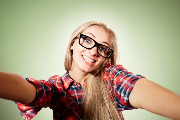 Young blonde woman taking selfie