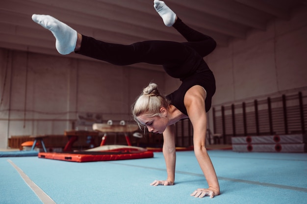Young blonde woman training for gymnastics championship