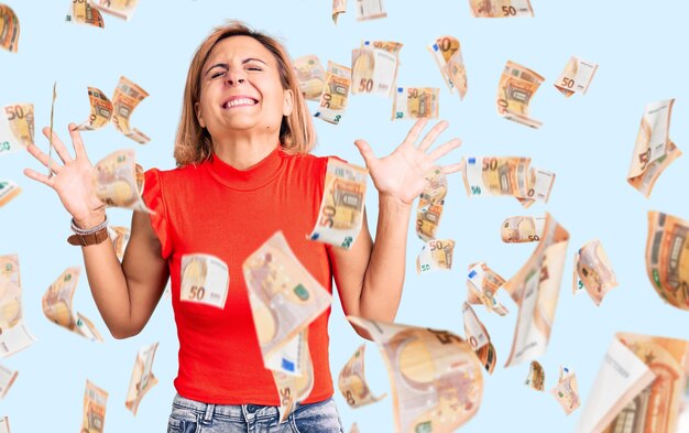 Free Photo young blonde woman wearing casual clothes celebrating mad and crazy for success with arms raised and closed eyes screaming excited. winner concept