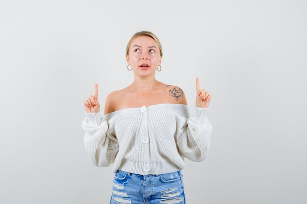 Young blonde woman in a white cardigan