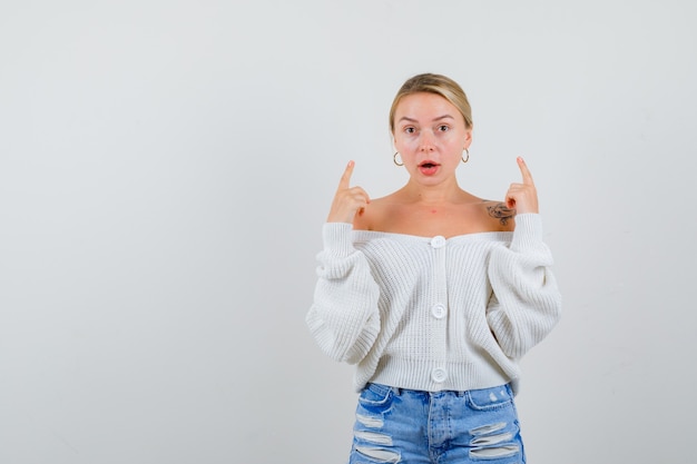 Young blonde woman in a white cardigan