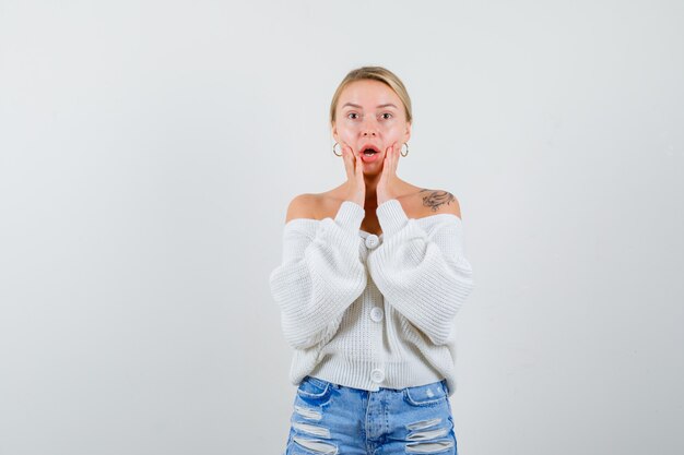 Young blonde woman in a white cardigan