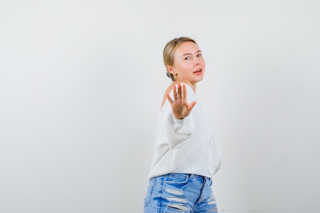 Young blonde woman in a white cardigan