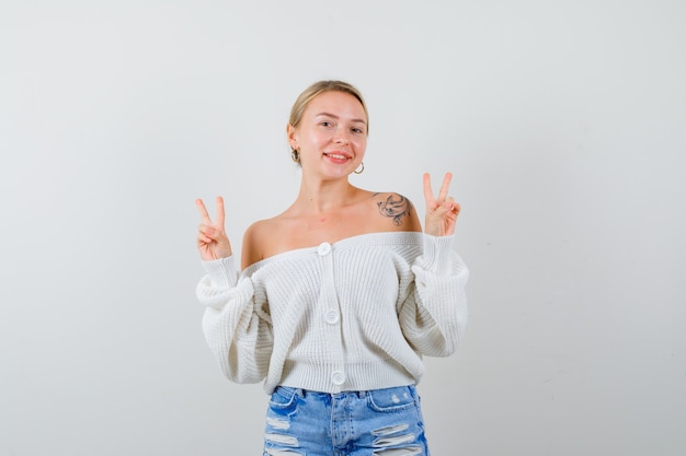 Young blonde woman in a white cardigan