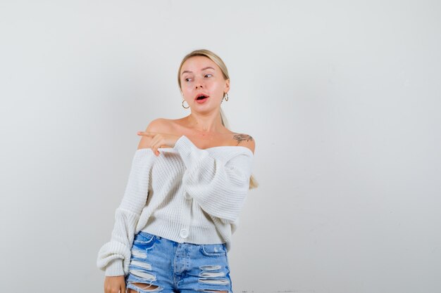 Young blonde woman in a white cardigan