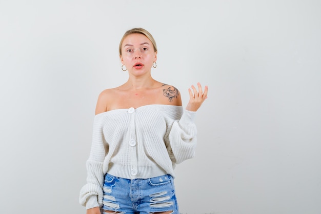 Young blonde woman in a white cardigan