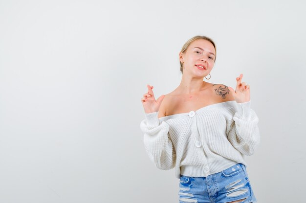 Young blonde woman in a white cardigan