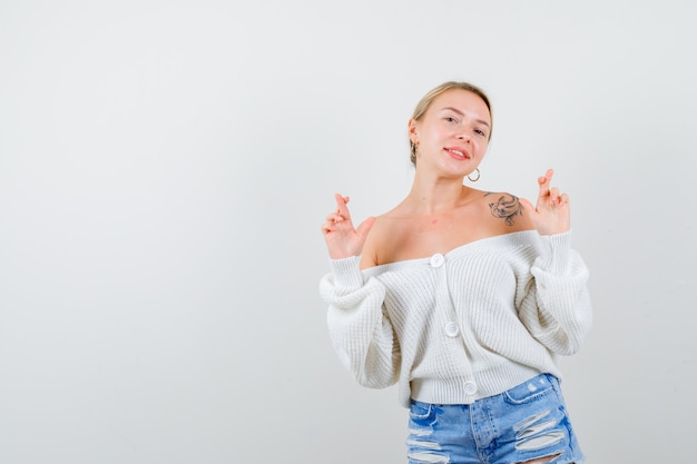 Young blonde woman in a white cardigan