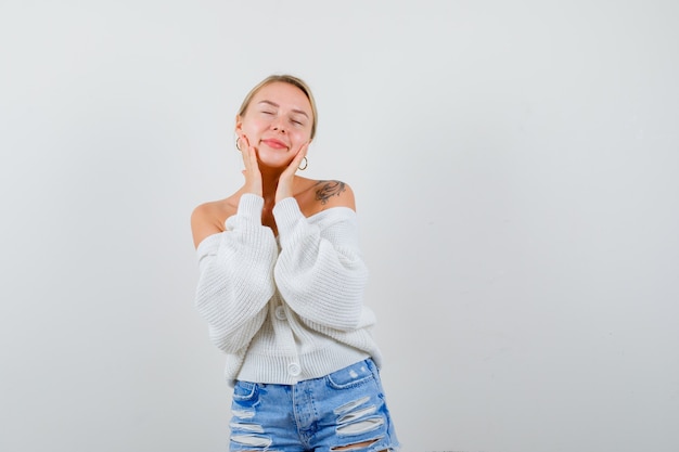 Young blonde woman in a white cardigan