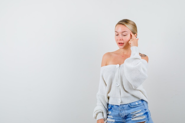 Young blonde woman in a white cardigan