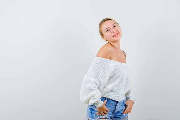 Young blonde woman in a white cardigan